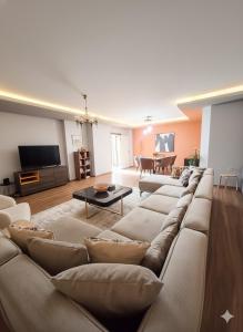 a living room with a large couch and a tv at Kaira Homes 2 in Ankara