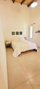 a bedroom with two beds and a tiled floor at Aires de Primavera in San Rafael +30 photos