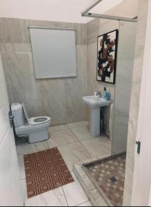 a bathroom with a toilet and a sink at The Mining Station in Randfontein