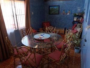a dining room with a glass table and chairs at China 18, Coquimbo in Coquimbo +6 photos