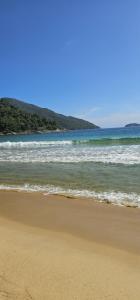 a sandy beach with the ocean in the background at casa da Cilene in Angra dos Reis