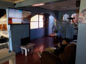 a man sitting on a couch in a living room at China 18, Coquimbo in Coquimbo