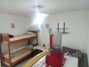 a room with a red blender and a bunk bed at Pousada Praia Grande Apartamento Familiar in Praia Grande +1 photo