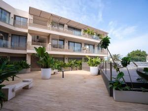a large building with plants in front of it at The Magic Place - Ocean Walk and Pool Access in Anfa-Supérieur