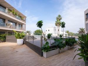 a courtyard with palm trees and plants in a building at The Iconic Spot - Pool and Sea View in Anfa-Supérieur