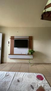 a living room with a flat screen tv on a wall at Apto 13 - Residencial Canaã in Porto Velho