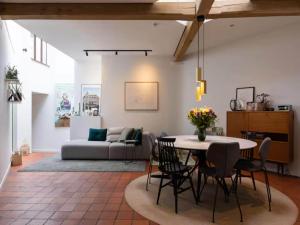 a living room with a table and chairs and a couch at Holiday home in the heart of Hasselt in Hasselt