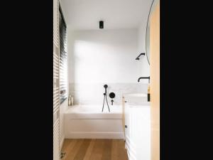 a white bathroom with a tub and a sink at Holiday home in the heart of Hasselt in Hasselt +16 photos