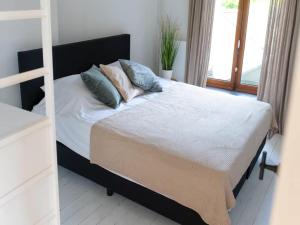 a bedroom with a bed with pillows on it at Holiday home in the heart of Hasselt in Hasselt