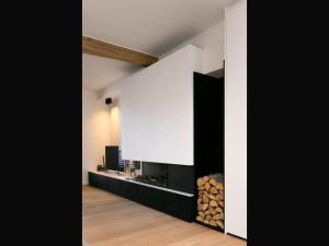 a room with a fireplace and a wall with logs at Holiday home in the heart of Hasselt in Hasselt