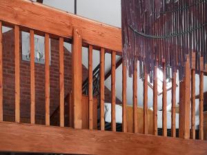 a wooden balcony with icicles hanging from it at Elm Barn Lodge in Freethorpe