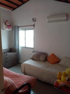 a bedroom with two beds and a window at Casa ciudad de la Costa in Ciudad de la Costa