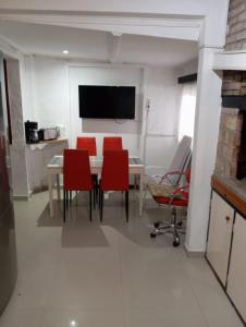 a dining room with a table and red chairs at Casa ciudad de la Costa in Ciudad de la Costa +25 photos