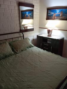 a bedroom with a bed and a dresser with a mirror at Casa ciudad de la Costa in Ciudad de la Costa