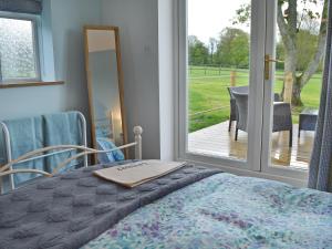 a bedroom with a bed and a sliding glass door at The Blue Loft in Rye +13 photos