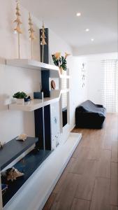 a living room with white shelves and a wooden floor at Punta Cana Aruba Beach Apartcomplex 1 in Punta Cana