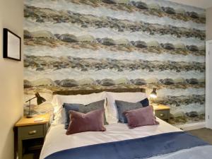 a bedroom with a large bed with two night stands at 2 Harney Peak in Portinscale