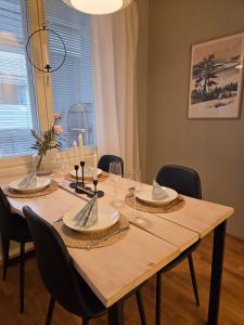 a dining room table with chairs and a large window at The Arctic Nordic Retreat in Rovaniemi +2 photos