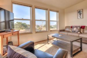 a living room with a couch and a tv at Starboard Cottage in Waldport