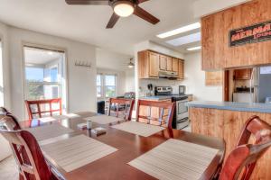 a kitchen and dining room with a table and chairs at Starboard Cottage in Waldport