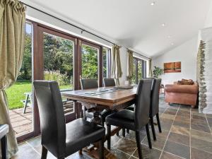 a dining room with a wooden table and chairs at Kite Cottage in Capel-Ifan