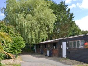 a small house with a tree next to it at Cider House in Launceston