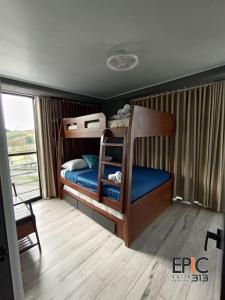 a bedroom with two bunk beds and a balcony at Epic Suite 313 Deluxe Airport Family 3H 10P in Cuba