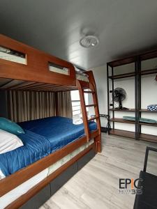 a bedroom with a bunk bed with blue sheets at Epic Suite 313 Deluxe Airport Family 3H 10P in Cuba +36 photos