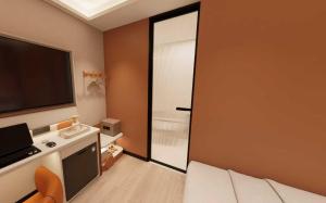 a room with a sliding glass door with a television at A Hotel Farrer Park - Newly Renovated in Singapore