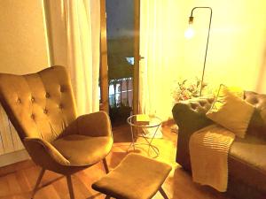a living room with a couch and a chair at Suite Legio VII in León +41 photos