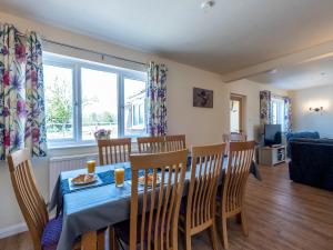 een eetkamer met een blauwe tafel en stoelen bij Old Alton Hall Farmhouse in Tattingstone