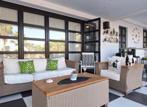 a living room with a white couch and a table at The Pervoli Studio - Pool - Close to Beach in Larnaka