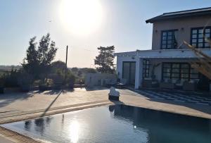 a house with a swimming pool in front of a house at The Pervoli Studio - Pool - Close to Beach in Larnaka
