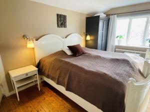 a bedroom with a large bed and a window at 5 person holiday home in Tving in Tving