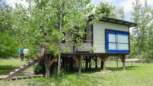 a tree house with a slide in a tree at La casita del bosque en Muelle Delta Arias in Tigre