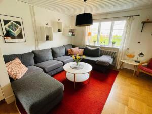 a living room with a couch and a table at 5 person holiday home in Tving in Tving