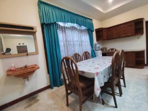a dining room with a table and chairs at Villa Graha Permata 1 in Batu