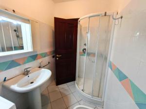 a bathroom with a sink toilet and a shower at Apartment with Pool and Private Parking in Porto Ottiolu +22 photos