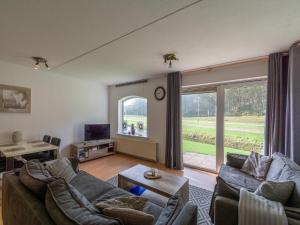 a living room with a couch and a large window at Apartment in Zoutelande near beach in De Zandloper