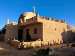 a building with a dome on top of it at Friendo's House & Hot Spring in Siwa
