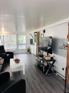 a living room with a couch and a tv at Beachfront Retreat w Pool, Boat Ramp & Dock Rental in Key Largo