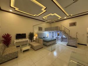 a large living room with a bed and a couch at The Orchard Haven in Islamabad