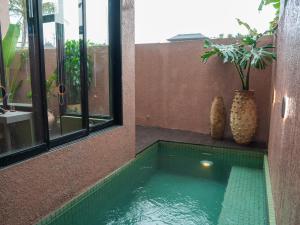 a small swimming pool in the corner of a building at Patha Canggu in Canggu