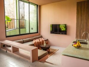 a living room with a couch and a large window at Patha Canggu in Canggu