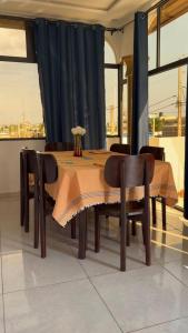 a dining room table and chairs with a black curtain at Paradis Douillet in Cotonou