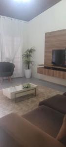 a living room with a couch and a coffee table at Home in Belém cop 30 in Belém