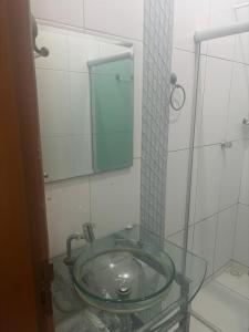a glass sink in a bathroom with a mirror at Home in Belém cop 30 in Belém