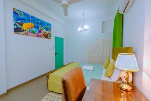 a living room with a table and a bed at Istana Villa Mirissa in Mirissa