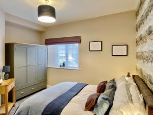 a bedroom with a bed and a window at 2 Harney Peak in Portinscale