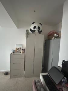 イルフォードにあるSpacious ensuite room in front of stationのキャビネットの上にパンダが乗っている寝室